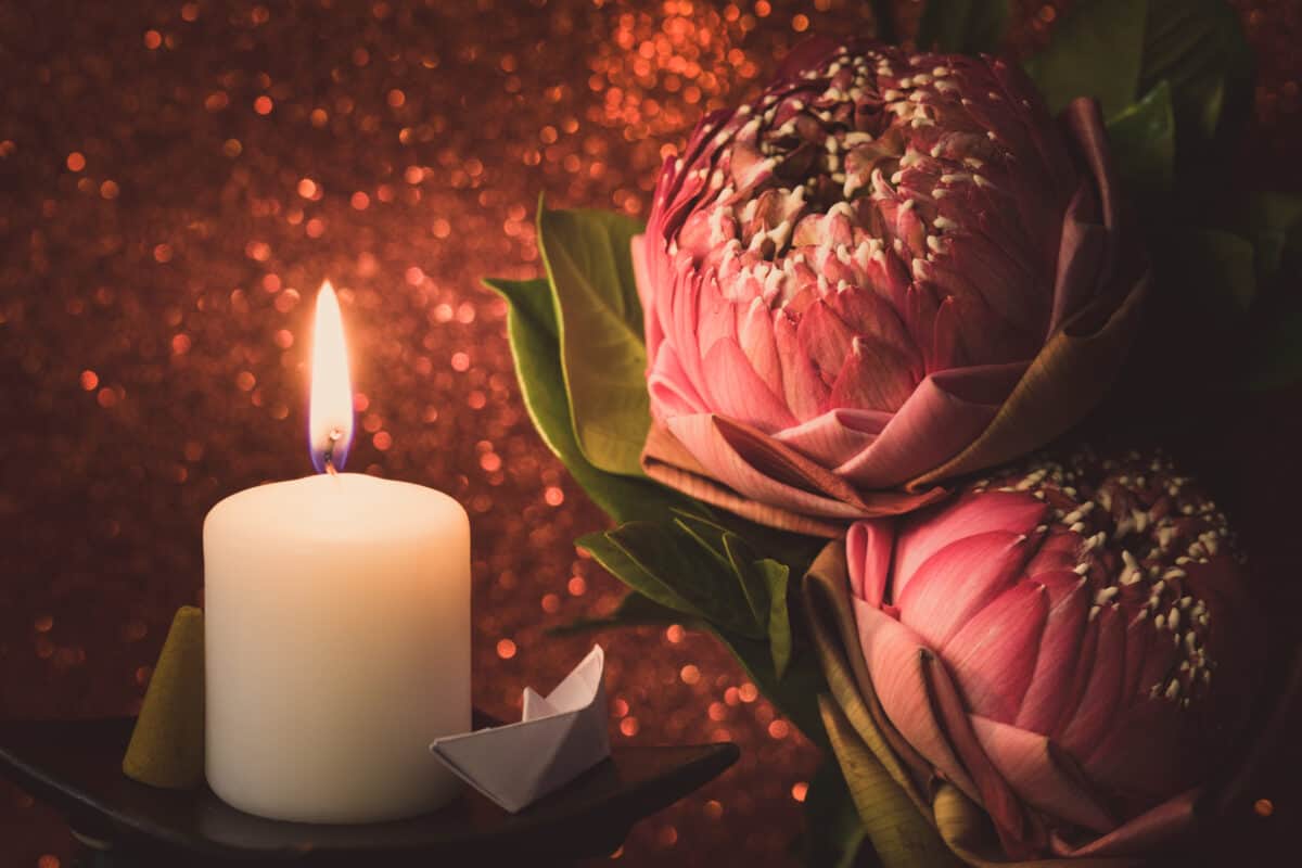 Vintage Image Style On Pink Water Lily Or Lotus Flower Folding Thai Style With White Candle Light For Worship With Red Bokeh Background